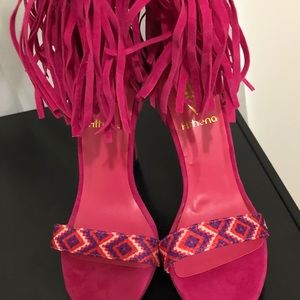 Fuchsia pink suede tassels peep toe heels.